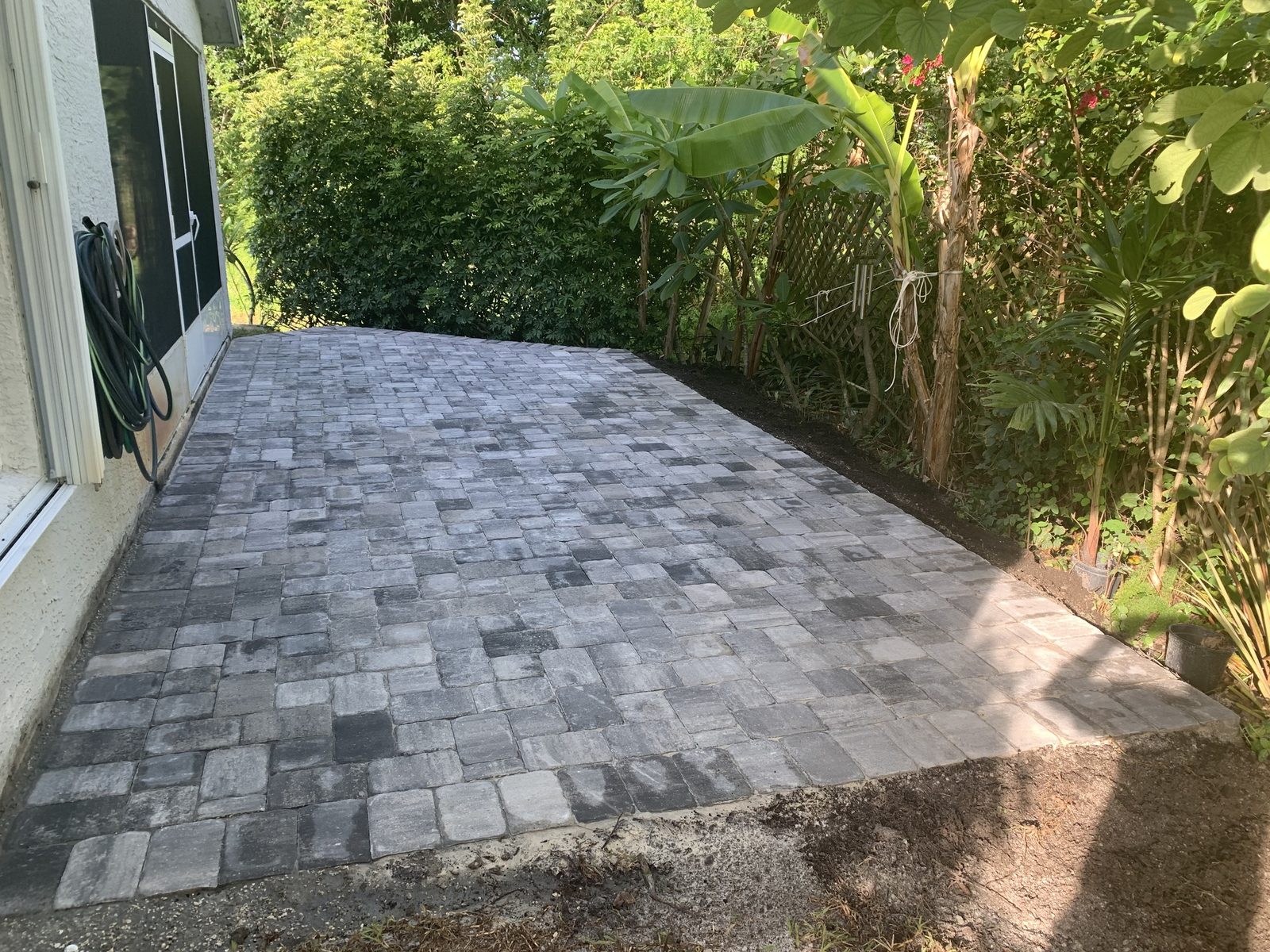 After: finished charcoal interlocking paver patio, an On Pace Pavers project